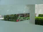 one of the show gardens seen through a viewport in the surrounding glass wall